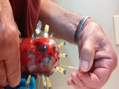 Man putting pins all over his cock